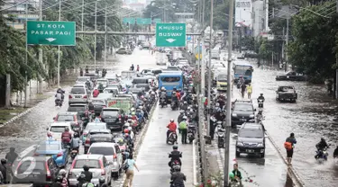 Sejumlah kendaraan terjebak saat mencoba melintas genangan banjir di Jalan Gunung Sahari, Jakarta, Kamis (21/4/2016). Hujan yang mengguyur Jakarta sejak tadi malam membuat beberapa ruas jalan Jakarta tergenang banjir. (Liputan6.com/Faizal Fanani)