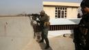 Pasukan Irak membidik sasaran saat terlibat kontak senjata dengan militan ISIS di Mosul, Irak (10/1). Pertempuran dengan militan ISIS kembali terjadi saat pasukan Irak sedang melakukan evakuasi warga Mosul. (AP Photo/Khalid Mohammed)