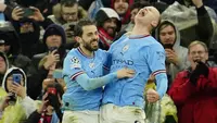 Manchester City sukses membungkam Bayern Munchen dengan skor telak 3-0 pada laga leg pertama babak perempatfinal Liga Champions 2022/2023 di Etihad Stadium, Rabu (12/4/2023) dini hari WIB. Tiga gol The Citizens masing-masing disumbangkan oleh Rodri pada menit ke-27, Bernardo Silva (70') dan Erling Haaland (76'). Dengan tambahan satu gol, Erling Halaand hingga kini telah mencetak total 45 gol di semua kompetisi musim ini dan mencatat rekor sebagai pemain tertajam Premier League di semua ajang dalam satu musim kompetisi. (AP Photo/Jon Super)