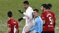 Gelandang Real Madrid, Casemiro, bersitegang dengan pemain Osasuna, Oier, pada laga Liga Spanyol di Stadion El Sadar, Sabtu (9/1/2021). Kedua tim bermain imbang 0-0. (AP/Alvaro Barrientos)