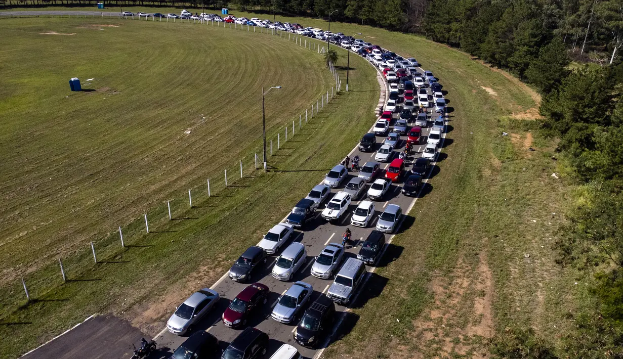 Pengemudi menunggu untuk menjalani tes PCR COVID-19 gratis di tempat pengujian drive-thru di arena pacuan kuda di Capiata, Paraguay, Selasa (11/1/2022).  (AP Photo/Jorge Saenz)