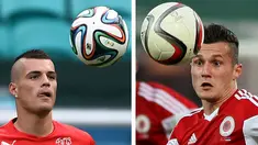 Pemain Albania Taulant Xhaka (kanan) dan pemain Swiss, Granit Xhaka. Kedua kakak beradik ini harus mengikuti gelaran piala Eropa 2016 dengan membela negara yang berbeda.(GENT SHKULLAKU ANNE-CHRISTINE POUJOULAT / AFP)