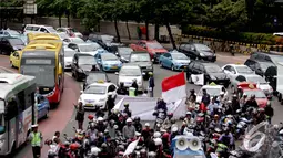 Aksi unjuk rasa menolak kebijakan larangan pengguna sepeda motor untuk melalui jalan Thamrin - Merdeka Barat membuat jalan sekitar mengalami kemacetan parah, Bundaran HI, Jakarta, Kamis (8/1/2015). (Liputan6.com/Faizal Fanani)