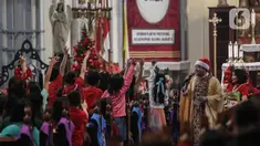 Pastor Kepala Paroki Romo Yohannes Deodatusi SJ menyapa anak-anak saat memimpin jalannya misa keluarga di Gereja Katedral, Jakarta, Rabu (25/12/2024). (Liputan6.com/Angga Yuniar)
