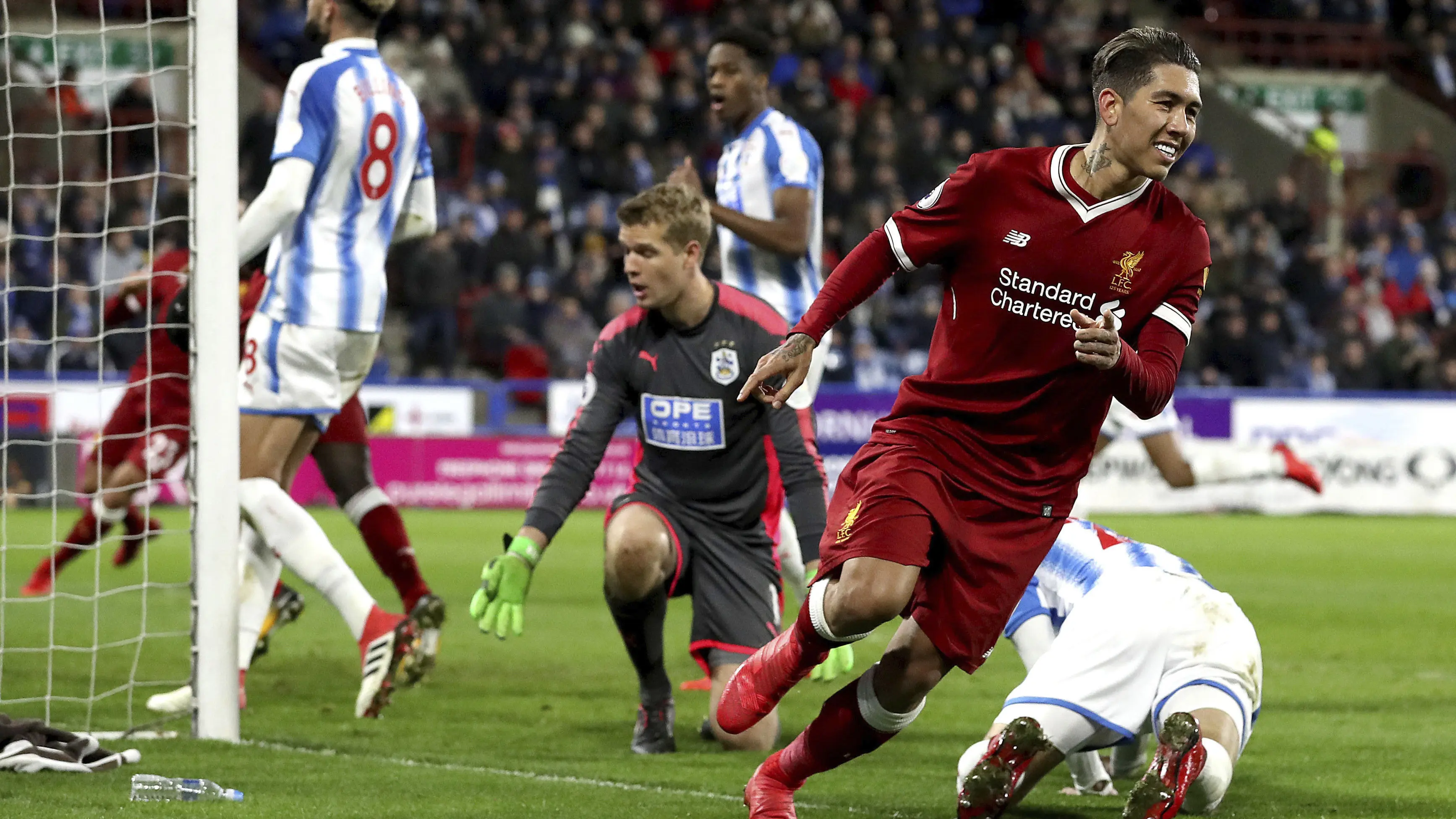 Pemain Liverpool, Roberto Firmino merayakan golnya ke gawang Huddersfield Town pada lanjutan Premier League di John Smith's Stadium, Huddersfield, (30/1/2018). Liverpool menang 3-0. (Martin Rickett/PA via AP)