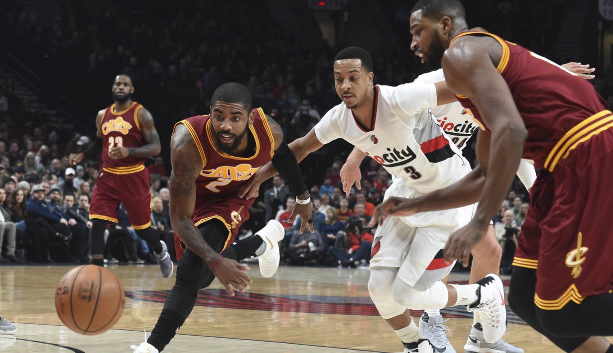 Pemain Cleveland Cavaliers, Kyrie Irving (kiri) berusaha mengejar bola bersama pemain Portland Trail Blazers, C.J. McCollum pada laga NBA basketball game di oda Center, Portland (11/1/2016). Blazers menang 102-86.  (AP/Steve Dykes)