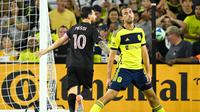 Inter Miami forward Lionel Messi (10) celebrates his goal behind Nashville SC defender Jack Maher, left, during the second half of a MLS soccer match Saturday, Oct. 28, 2025, in Nashville, Tenn.﻿ (AP Photo/John Amis)