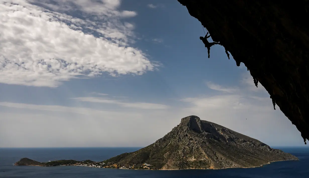 Peserta dalam Festival Mendaki tahunan 2019 di pulau Kalymnos (4/10/2019). Pemandangan yang menakjubkan dan kondisi cuaca yang bagus menjadikan pulau Kalymnos di Yunani sebagai tujuan utama bagi pemanjat tebing internasional dari semua tingkatan dengan lebih dari 2500 rute pendakian. (AFP Photo/Aris