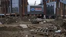 Puing-puing banjir tertinggal di dekat gedung perkantoran komersial setelah banjir dari sungai yang meluap di distrik Mentougou di pinggiran Beijing pada Senin, 7 Agustus 2023. (AP Photo/Andy Wong)