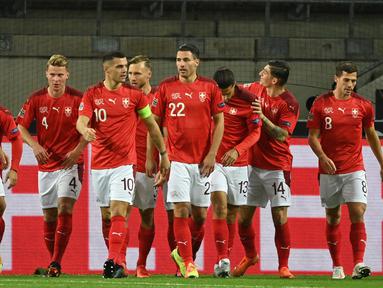 Pemain Swiss merayakan gol yang dicetak Mario Gavranovic ke gawang Jerman pada laga lanjutan UEFA Nations League 2020/2021 di RheinEnergie Stadion, Rabu (14/10/2020). Jerman bermain imbang 3-3 atas Swiss. (AFP/Ina Fassbender)