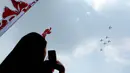 Warga menyaksikan atraksi pesawat dalam perayaan HUT ke-81 Kemerdekaan Republik Indonesia di kawasan Istana Merdeka, Jakarta, Senin (17/8/2026). Sejumlah pesawat tempur dan helikopter TNI-Polri tampil dalam rangkaian atraksi udara yang memeriahkan perayaan kemerdekaan, termasuk manuver dan formasi di langit Jakarta. (KLY/Budy Santoso)