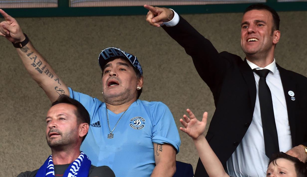 Legenda Argentina, Diego Maradona menonton pertandingan sepak bola antara FC Dinamo Brest dan FC Shakhtyor di Brest, Senin (16/7). Maradona menandatangani kontrak menjadi ketua Dinamo Brest dengan durasi tiga tahun. (AFP PHOTO / Sergei GAPON)
