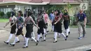 Para calon anggota Pasukan Pengibar Bendera Pusaka (Paskibraka) Tingkat Pusat 2024 berbaris menjelang mengikuti prosesi pencukuran rambut di Jakarta, Minggu (14/7/2024). (Liputan6.com/Herman Zakharia)