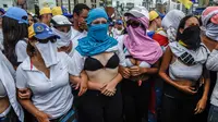 Sejumlah wanita membuka kausnya saat berunjuk rasa menentang Presiden Venezuela Nicolas Maduro di Caracas, Sabtu (6/5). Mereka meneriakkan “Liberty” dan wanita-wanita tersebut menyebut Maduro sebagai seorang diktator. (AFP PHOTO / JUAN BARRETO)