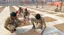 Taruna Korps Kadet Nasional menata lampu tanah di tepi sungai Saryu di Ayodhya, India, Selasa (2/11/2021). Ratusan ribu lampu akan dinyalakan pada perayaan Deepotsav pada malam Diwali. (AP Photo/Rajesh Kumar Singh)