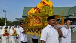 Warga membawa hidangan menu makanan selama perayaan maulid akbar Nabi Muhammad SAW di Banda Aceh, Aceh, Kamis (6/2/2020). Acara maulid akbar tersebut menyediakan 808 hidangan dari 90 desa dan instansi pemerintah dengan mengundang 25.000 tamu dari berbagai daerah. (Photo by Chaideer MAHYUDDIN / AFP)