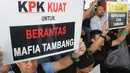Seorang aktivis membentangkan poster saat menggelar aksi di halaman gedung KPK, Jakarta, Jumat (13/3/2015). Mereka menolak kriminalisasi KPK yang selama ini konsisten memberantas korupsi khususnya disektor sumber daya alam. (Liputan6.com/Herman Zakharia)
