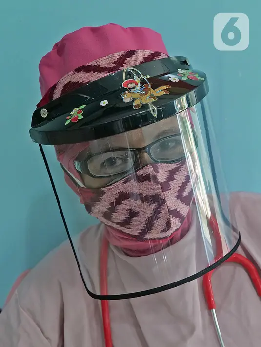 dr. Diah Pramita berpose dengan penutup kepala dan masker bertema tenun NTT seusai memeriksa pasien di RSIA Tambak, Jakarta, Kamis (18/6/2020). (Liputan6.com/Herman Zakharia)