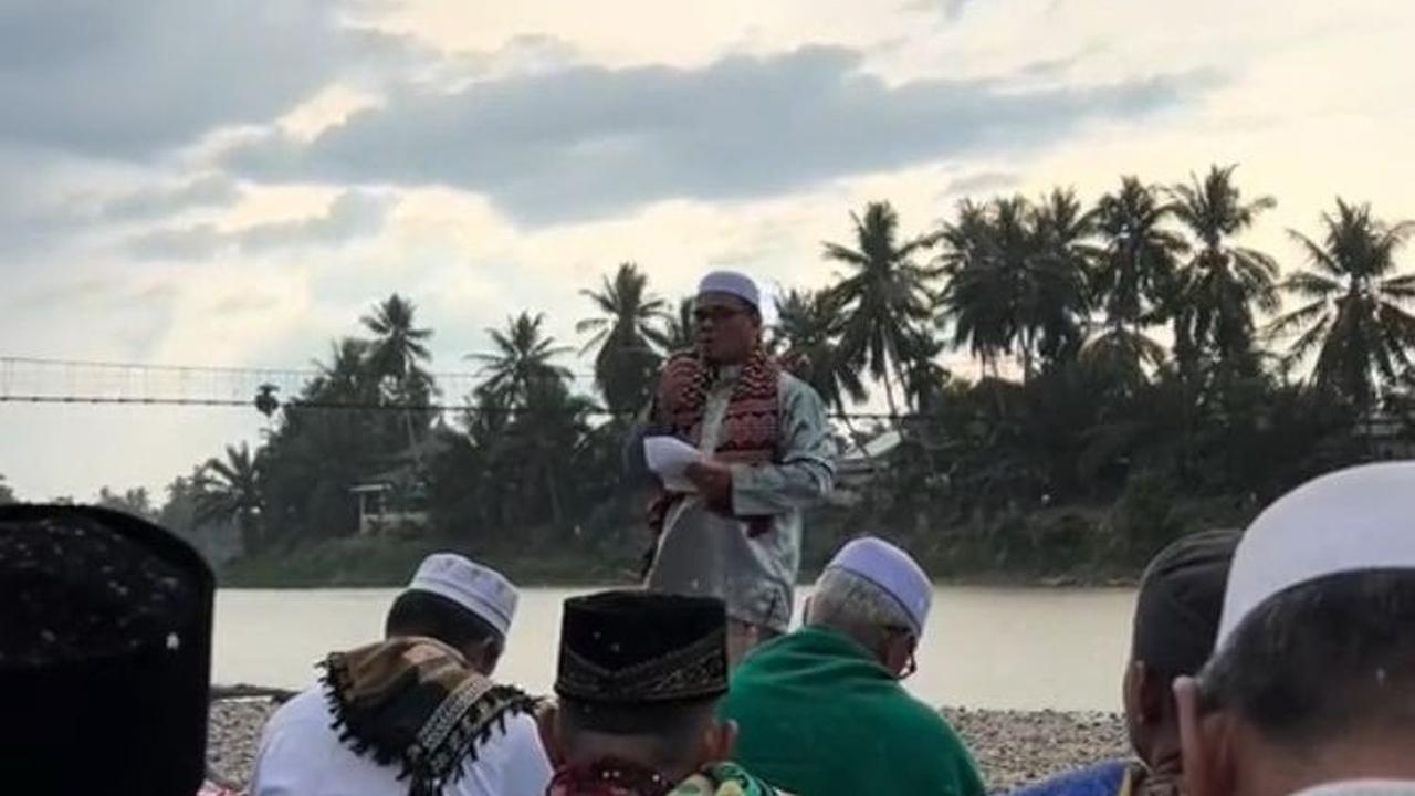 Sambil mendengarkan khutbah, gerimis yang awalnya kecil turun semakin deras dan mulai membasahi pakaian para jemaah.