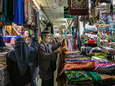 Calon pembeli memilih perlengkapan ibadah di pasar Tanah Abang Jakarta, Sabtu (17/4/2021). Saat bulan Ramadhan, umat muslim ramai berbelanja perlengkapan ibadah seperti, tasbih, sajadah, peci dan baju muslim untuk dipergunakan saat beribadah di bulan suci. (Liputan6.com/Faizal Fanani)