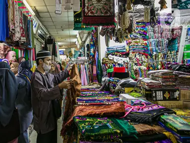 Calon pembeli memilih perlengkapan ibadah di pasar Tanah Abang Jakarta, Sabtu (17/4/2021). Saat bulan Ramadhan, umat muslim ramai berbelanja perlengkapan ibadah seperti, tasbih, sajadah, peci dan baju muslim untuk dipergunakan saat beribadah di bulan suci. (Liputan6.com/Faizal Fanani)