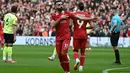 Empat menit berselang, Liverpool berbalik unggul lewat eksekusi penalti Mohamed Salah. (Paul ELLIS/AFP)