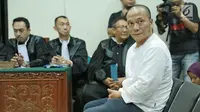 Rapper Iwa K duduk diruangan saat menjalani sidang perdana di Pengadilan Negeri Tangerang, Rabu (6/9). Pelantun 'Nombok Dong' tersebut terbukti membawa ganja seberat 1,485 gram dalam 3 linting rokok. (Liputan6.com/Pool)