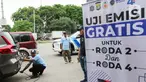 Petugas melakukan uji emisi kendaraan di kawasan Jalan Perintis Kemerdekaan, Kelapa Gading, Jakarta Utara, Selasa (3/12/2024). (Liputan6.com/Herman Zakharia)