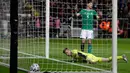 Kiper Irlandia Utara Bailey Peacock-Farrell dan rekan timnya, Tom Flanagan bereaksi setelah pemain Timnas Jerman, Leon Goretzka mencetak gol pada laga Grup C Kualifikasi Piala Eropa 2020 di Commerzbank Arena, Selasa (19/11/2019). Timnas Jerman benamkan Irlandia Utara 6-1. (AP/Michael Probst)