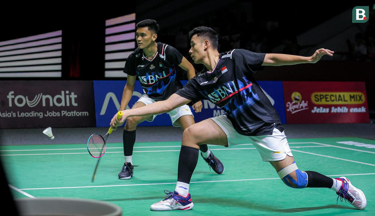 Pebulu tangkis ganda putra Indonesia, Bagas Maulana/Muhammad Shohibul Fikri berusaha menjangkau kok saat bertanding melawan pasangan Denmark, Kim Astrup/Anders Skaarup Rasmussen pada babak perempat final Indonesia Open 2024 di Istora Senayan, Jakarta, Jumat (07/06/2024). (Bola.com/Bagaskara Lazuardi)