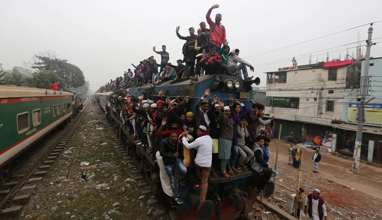 Muslim Bangladesh berada di atas kereta yang penuh sesak setibanya untuk menghadiri pertemuan Muslim tahunan 'Biswa Ijtema' di Dhaka, Minggu (12/1/2020). Bishwa Ijtema merupakan merupakan pertemuan terbesar kedua Muslim di dunia setelah haji. (AP/Mahmud Hossain Opu)