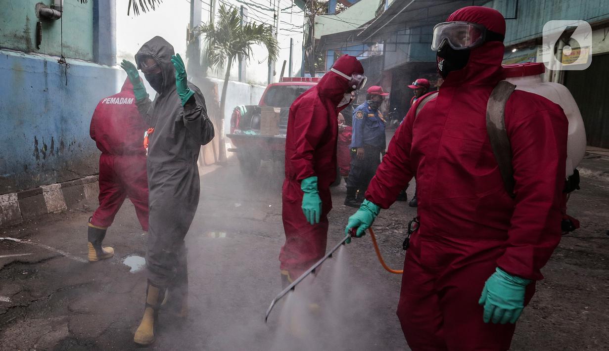 Petugas menyemprotkan Cairan Disinfektan di Pasar Palmerah, Jakarta, Kamis (25/6/2020). Penyemprotan dilakukan guna mencegah dan memutuskan mata rantai penyebaran Covid-19 di Area pasar Palmerah. (Liputan6.com/Johan Tallo)