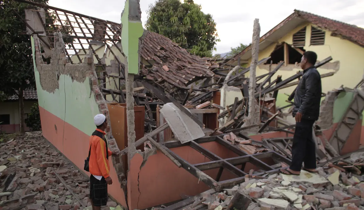 Penduduk desa memeriksa rumah mereka yang rusak setelah gempa magnitudo 5,1  di Sukabumi, Jawa Barat (10/3/2020). Pusat gempa tepatnya berlokasi di darat pada jarak 23 kilometer arah Timur Laut Kota Pelabuhan Ratu, Kabupaten Sukabumi, Jawa Barat pada kedalaman 10 kilometer. (AFP/Wulung Widarba)