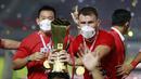 Pemain Persija Jakarta, Marco Motta, melakukan selebrasi dengan mengangkat trofi usai menjuarai Piala Menpora 2021 di Stadion Manahan, Solo, Minggu (25/4/2021). (Bola.com/M Iqbal Ichsan)