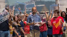 Pelatih Manchester City Pep Guardiola memegang kotak surat dalam aksi menuntut kemerdekaan Catalonia, di Barcelona, Minggu (11/6). Catalonia secara sepihak merencanakan menggelar referendum untuk berpisah dari Spanyol pada 1 Oktober. (AP/Emilio Morenatti)