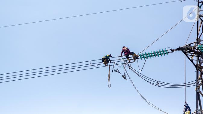 Pekerja memperbaiki kabel listrik Pembangkit Listrik Tenaga Uap (PLTU) Banten 3 Lontar, di Kabupaten Tangerang, Rabu (29/4/2020). PLN (Persero) memutuskan untuk menunda sejumlah proyek listrik meski berpotensi mengganggu jalannya program 35.000 MW. (Liputan6.com/Fery Pradolo)