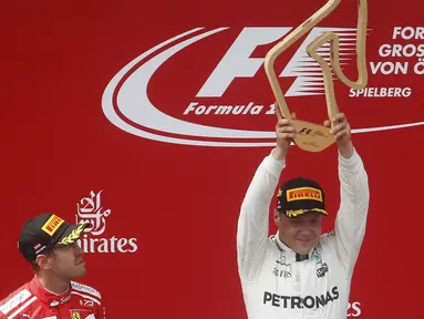 Pebalap Mercedes, Valtteri Bottas, mengangkat trofi usai berhasil menjuarai F1 GP Austria di Sirkuit Red Bull Ring, Minggu (9/7/2017). Valtteri Bottas menjadi yang tercepat dengan catatan waktu 1 jam 21 menit 48,527 detik. (AP/Darko Bandic)