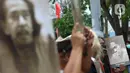 Sejumalah seniman membawa foto tokoh dan seniman saat mengikuti Karnaval Seni Budaya di Taman Ismail Marzuki, Jakarta, Rabu (10/11/2021). Karnaval tersebut menampilkan pertunjukan seni budaya digelar  sebagai rangkaian perayaan HUT ke-53 Taman Ismail Marzuki (TIM). (Liputan6.com/Herman Zakharia)