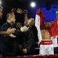 Wasit asal Indonesia, Nus Ririhena mengangkat tangan Daud Yordan tanda kemenangan pada laga bertajuk "Battle Of the Champions : Road To Glory" di OCBC Arena, Singapura, Sabtu (25/3/2017). Daud menang KO atas Campee. (Bola.com/Nicklas Hanoatubun)