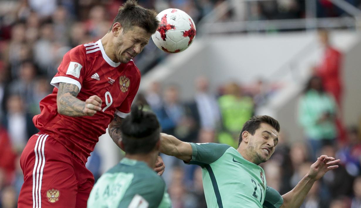 Pemain Rusia, Fedor Smolov (atas) berebut bola dengan para pemain Portugal pada laga grup A Piala Konfederasi 2017 di Spartak Stadium, Moscow, (21/6/2017). Portugal menang 1-0. (AP/Ivan Sekretarev)