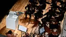 Robot Humanaid YuMi saat memimpin konser Lucca Philharmonic Orchestra di The Teatro Verdi di Pisa, Italia (12/9). Robot YuMi dibuat di Swiss dengan satu lengan memegang tongkat dan lengan lainnya memacu senar. (AFP Photo/Miguel Medina)