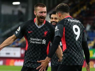 Bek Liverpool, Nathaniel Phillips (kiri) melakukan selebrasi bersama Roberto Firmino usai mencetak gol kedua timnya ke gawang Burnley dalam laga lanjutan Liga Inggris 2020/2021 pekan ke-37 di Turf Moor, Burnley, Rabu (19/5/2021). Liverpool menang 3-0 atas Burnley. (AFP/Alex Livesey/Pool)
