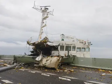 Kapal tanker saat menabrak jembatan yang menghubungkan ke Bandara Internasional Kansai akibat hantaman angin topan jebi di kota Izumisano, Osaka, (4/9). Topan Jebi yang melanda Jepang kali ini yang terkuat selama 25 tahun terakhir. (AFP Photo/Jiji Press)