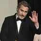 Aktor Joaquin Phoenix berpose dengan piala Oscar 2020 di ruang pers di  Dolby Teater, Los Angeles, Minggu (9/2/2020). Joaquin Phoenix yang memerankan karakter Arthur Fleck dalam film Joker, meraih penghargaan Oscar 2020 untuk kategori aktor terbaik. (AP Photo/Jordan Strauss)