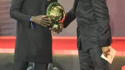 Mantan penyerang Kamerun Samuel Eto'o (kanan) memberi selamat kepada penyerang Senegal Sadio Mane (kiri) setelah memenangkan penghargaan Pemain Terbaik Afrika 2019 selama CAF Awards di kota wisata Mesir, Hurghada (7/1/2020). (AFP/Khaled Desouki)