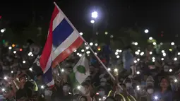 Pengunjuk rasa pro-demokrasi mengibarkan bendera selama protes di Sanam Luang di Bangkok, Thailand (19/9/2020). Para pengunjuk rasa mengulangi tuntutan agar monarki Thailand tetap berada di bawah konstitusi dalam demonstrasi terbesar sejak kudeta militer pada 2014. (AP Photo/Wason Wanichakorn)