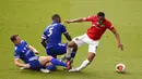 Penyerang Manchester United, Anthony Martial, terjatuh saat berebut bola dengan pemain Leicester City, Jonny Evans, pada laga Premier League di Stadion King Power, Minggu (26/7/2020). Manchester United menang dengan dua gol tanpa balas. (Oli Scarff/Pool via AP)