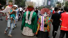 Pengamen ondel-ondel meminta sumbangan kepada warga di lokasi car free day, Jakarta, Minggu (21/5). Ramainya pengunjung CFD menyebabkan banyak pengamen mencari rezeki di kegiatan yang berlangsung setiap minggu tersebut. (Liputan6.com/Immanuel Antonius)