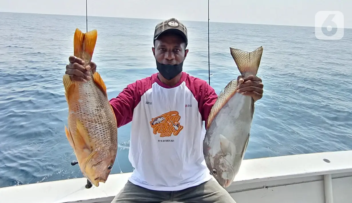 Pemancing menunjukkan ikan hasil tangkapannya pada kegiatan BNI Fun Fishing 2021 di perairan Selat Sunda, Banten, Sabtu (16/10/2021). Para pemancing berlomba-lomba mencari ikan terbesar dan terbanyak yang bisa dibawa pulang. (Liputan6.com/HO/Fun Fishing)