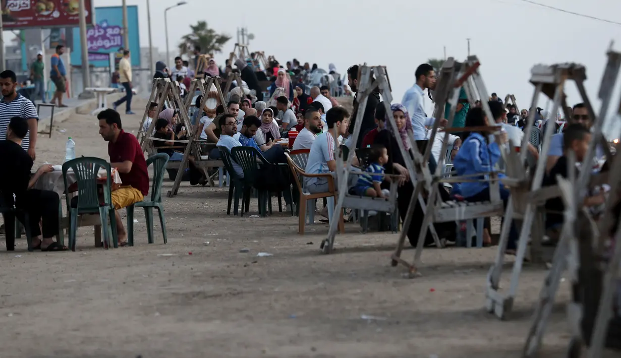Suasana berbuka puasa saat bulan suci Ramadan di pantai Kota Gaza, Palestina, Kamis (21/5/2020). Di tengah pandemi COVID-19, berbuka puasa bersama di pantai Kota Gaza tetap ramai. (AP Photo/Adel Hana)